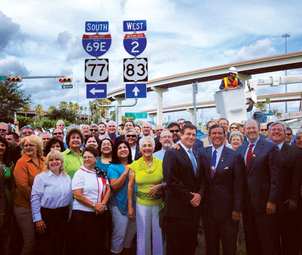 Several local, state and federal officials, as well as local residents, gather for a photo in front of the new I-69 signage that was unveiled by TXDOT during a ceremony on Monday, July 15, 2013, at the U.S. 83 and 281 interchange in Harlingen.  Photo: valleycentral.com