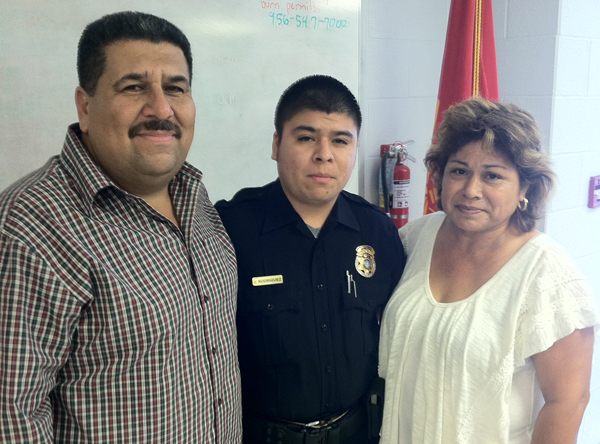 Officer Jesus Rodriguez stands with his parents Jesus & Blanca Rodriguez.