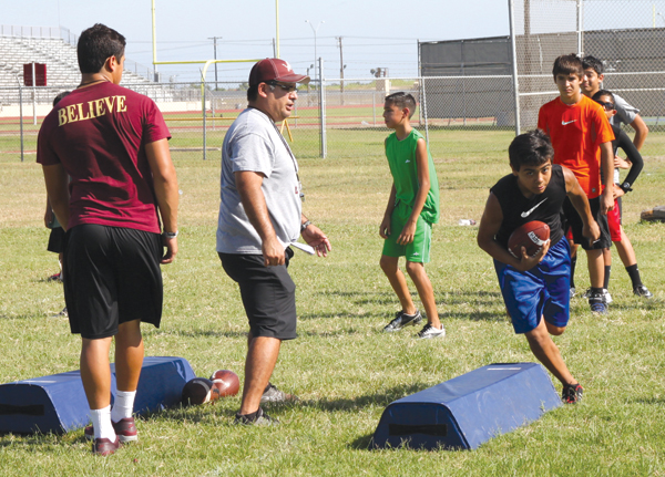 LFHS Coach Pete Martinez help the boys during a skills drill.