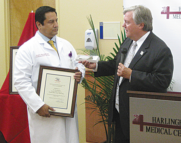 Harlingen Mayor Chris Boswell presents declaration plaque and city keys to Doctor Daniel Martinez, Head of Cardiovascular Care Program.