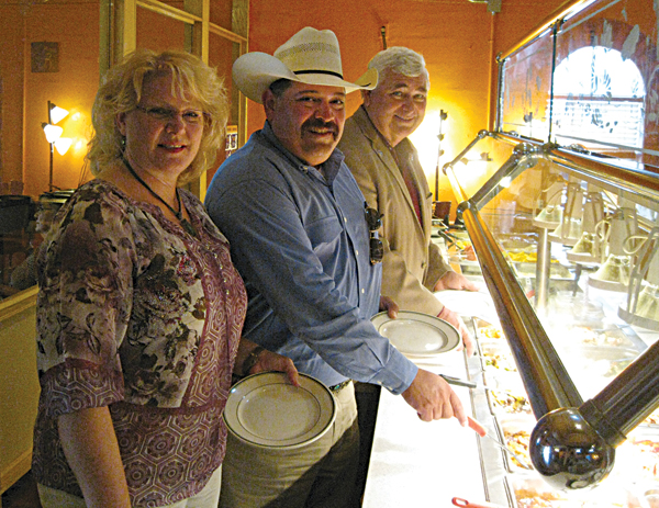 Lori Weaver, Judge Mike Trejo and Mayor Steve Brewer accept Angie’s invitation to sample her buffet.