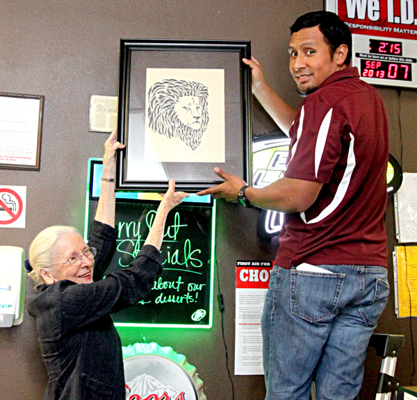 Bernice helps Eddie Casas find just the right place to hang the new addition LFN Photos by David Briones