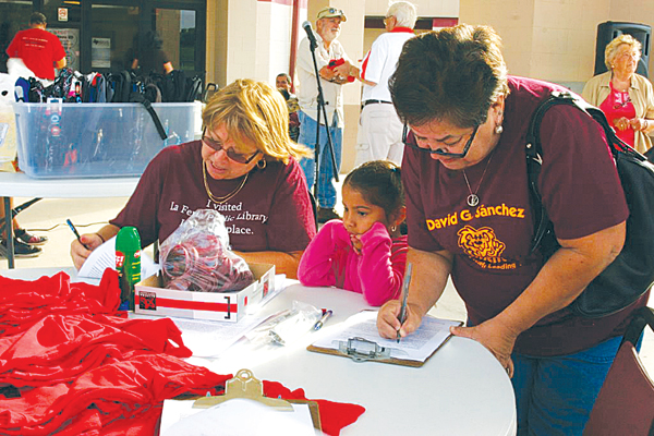 Volunteers help participants register for the event.
