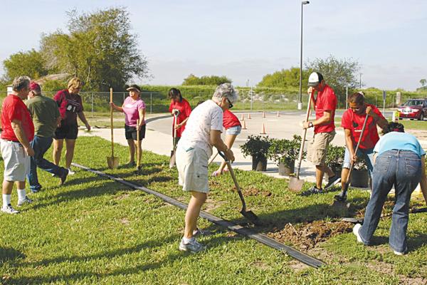 Volunteers planting flowers and trees last year for the beautification of David G. Sanchez Elementary in La Feria.