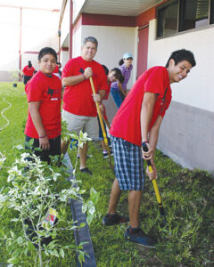 Brad Shields and several La Feria High students pitch in during the Sanchez Elem. Beautification.