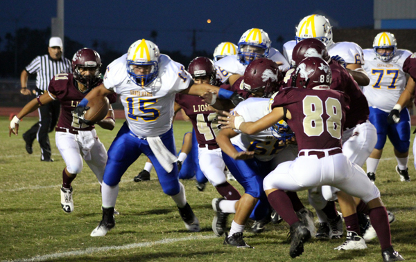 A pack of Lions bring down the Cougar running back. Photos: David Briones/LFCISD.