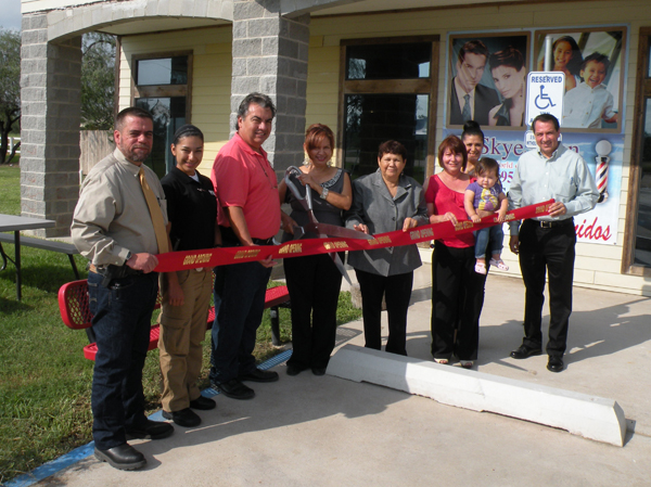 Mary Torres cuts the ribbon.  Sharing the event are (l-r) Police Chief Patrick Quill,Jeanette Gonzalez, Reserve police officer, Mayor pro-tem Rene Estrada.