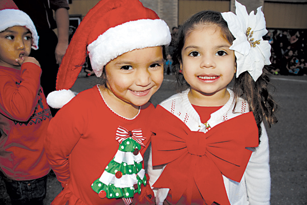 Two three-year-old pre-school cuties from Sam Houston Elementary were all smiles before their performance at the Lighting of the Tree. Joselyn Badillo and Lexi Frausto are ready for the holiday season. The girls are students in Ms. A. Guevara’s class. See more photos on page 8 and online at laferianews.net      Photo: MB Wright/LFN