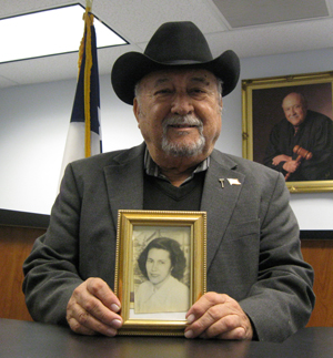 Judge Arturo Salas holds picture of his mother on her 100th birthday Celebration.