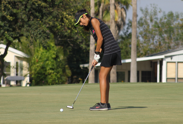 Isabel Prado finishes her shot with an easy putt.