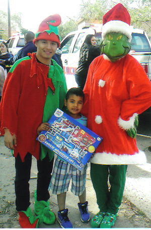 Elves and Costumed Characters helped the La Feria Police officers distribute hundreds and hundreds of gifts for local children during “Operation Smile”