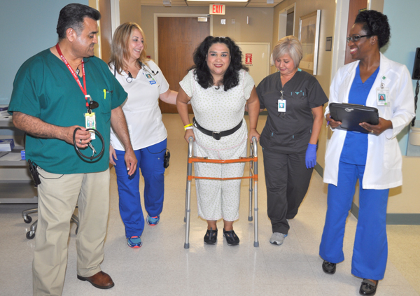 Maria A. DeLeon of Brownsville walks again after knee replacement surgery with the help of specially-trained orthopedics nurses and other health professionals at Valley Baptist Medical Center in Harlingen, including from the left, Samuel Sanchez, Patient Care Technician; Aileen Klusmann, Registered Nurse; Myrna Cuellar, Licensed Physical Therapy Assistant; and Maureen Rattray, RN, Nurse Director for the Valley Baptist’s orthopedics unit.