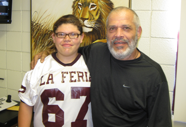 Football player Domonique C. Cox with her father at William B Green. Middle School.