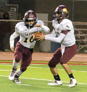  Isaac Galpin hands off the ball to Adrian Torres.