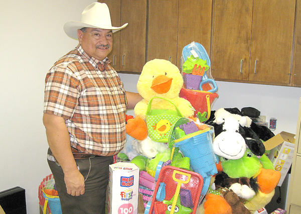 Chief Garcia shows just some of the prizes to be given away. Photo: Bill Keltner/LFN