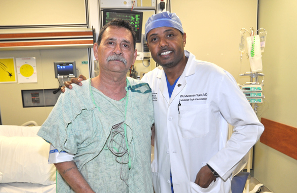 Dr. Wondwossen Tekle, right, Endovascular Neurologist at Valley Baptist Medical Center in Harlingen, checks on Alfonso Soto Jr. of Weslaco the day after Mr. Soto survived a severe stroke or “brain attack”. 