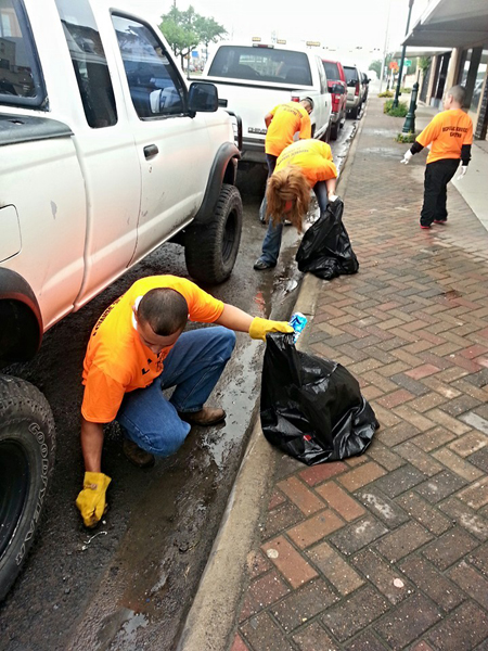 Volunteers collect trash along Main Street. Photo: City of La Feria