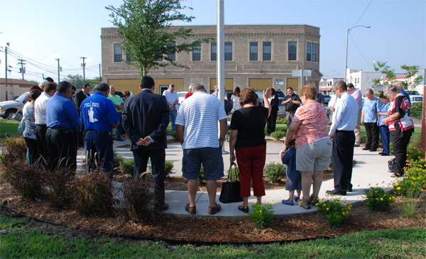La Feria city, school and church leaders form a circle around the city hall flag pole in observance of the National Day of Prayer in May 2013. Photo: MB Wright/LFN