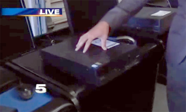 A reporter for KRGV-TV demonstrates one of the computer consoles seized from Lucky Big Bees Gaming Parlor in La Feria by Operation Bishop investigators during a report on June 30. Photo: KRGV-TV
