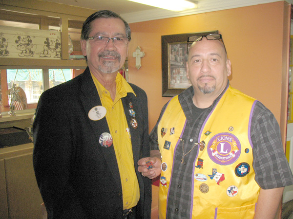 Picture of Mercedes Lions President, Leo Villarreal, presenting pin to District Governor, Juan Lopez