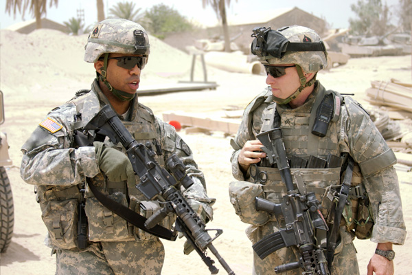 An African American soldier and white soldier working together. Photo: Rockfinder/TNS.