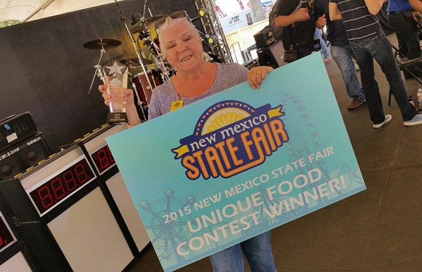 Donna Hernandez holds up the trophy for grand prize in the Unique Foods category. Photo: Cowboy Nut Shoppe.