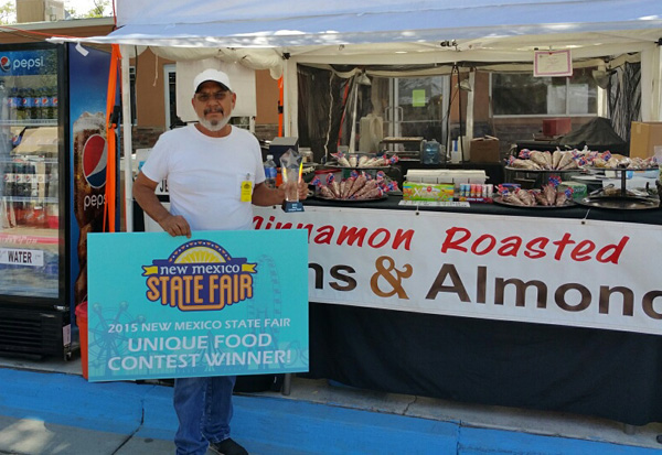 Mike Hernandez stands in front of his display at the New Mexico State Fair. Photo: Cowboy Nut Shoppe.