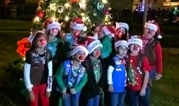 Girl Scout Troop #356 pose in front of the City Christmas Tree after this year’s event. Photo: Vanessa Tobias-Cano/Facebook.