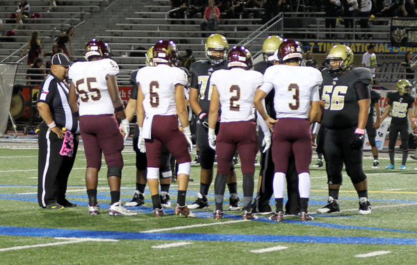 Captains meet for the coin flip.