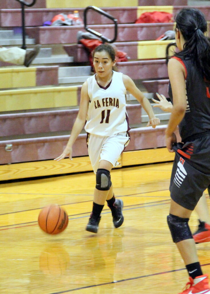 Karina Diaz drives the ball down the court.