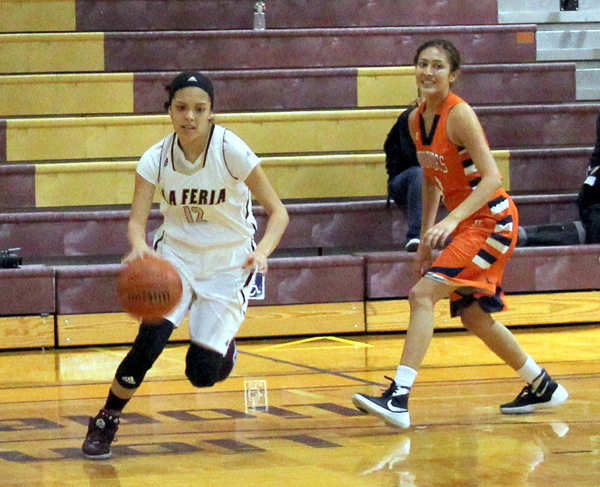Camryn Lopez drives the ball down the court.