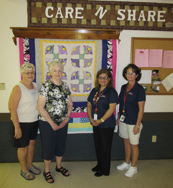 Phyllis Miles, Joyce Holder Rosie Cabrera and Karen Davis of KENWOOD RV PARK show one of their beautiful quilts.