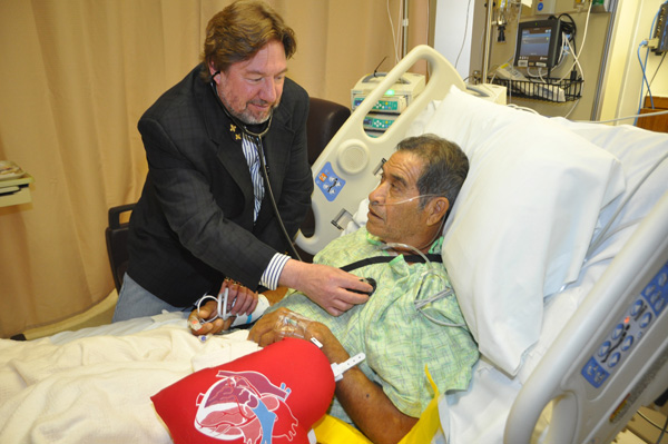 Dr. Mark Morales, a new Cardiovascular Surgeon who is now performing minimally-invasive heart surgeries in Harlingen and Brownsville, checks on patient Jacobo Salinas at Valley Baptist Medical Center in Harlingen. 