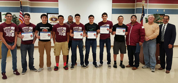  La Feria School Board President Alan Moore and La Feria Independent School District Superintendent Raymundo P. Villarreal, Jr. stand with La Feria High School students who were named to the 32-4A All District Boys Basketball Team and to the Team for their District Championship and their coaches.