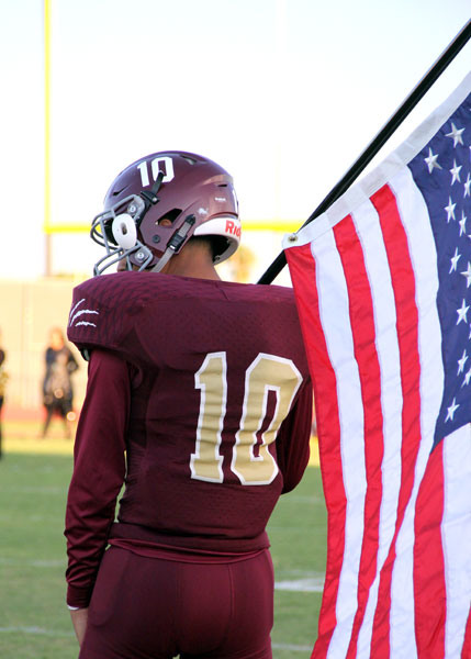 Trey Azua holding the US flag before the game.