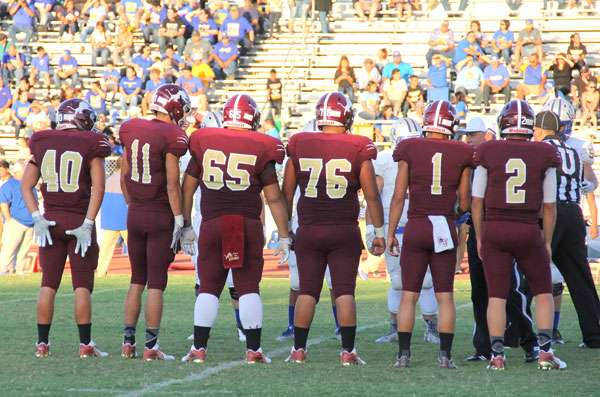 Captains meet at mid field for the coin toss.