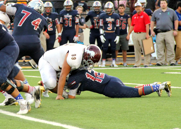 Israel Rodriguez brings down the Eagle ball carrier.