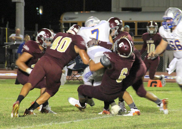 Bearkat quarterback is brought down by a pack of Lions. Photos: David Briones/LFISD