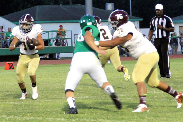 Michael Villarreal throws a block for the running back.