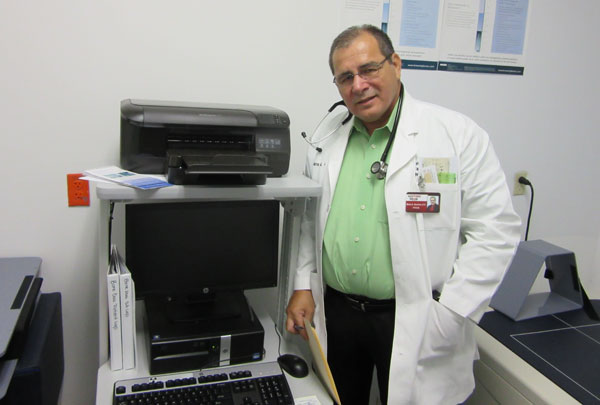 Doctor Sanchez demonstrates his new bone densitometry unit