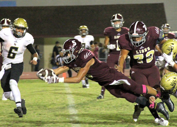 Julian Trevino dives into the endzone for a touchdown. Photo: David Briones/LFISD